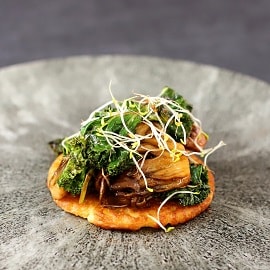 Sprouted chickpeas, socca pancake, kale, and BBQ maitake mushrooms